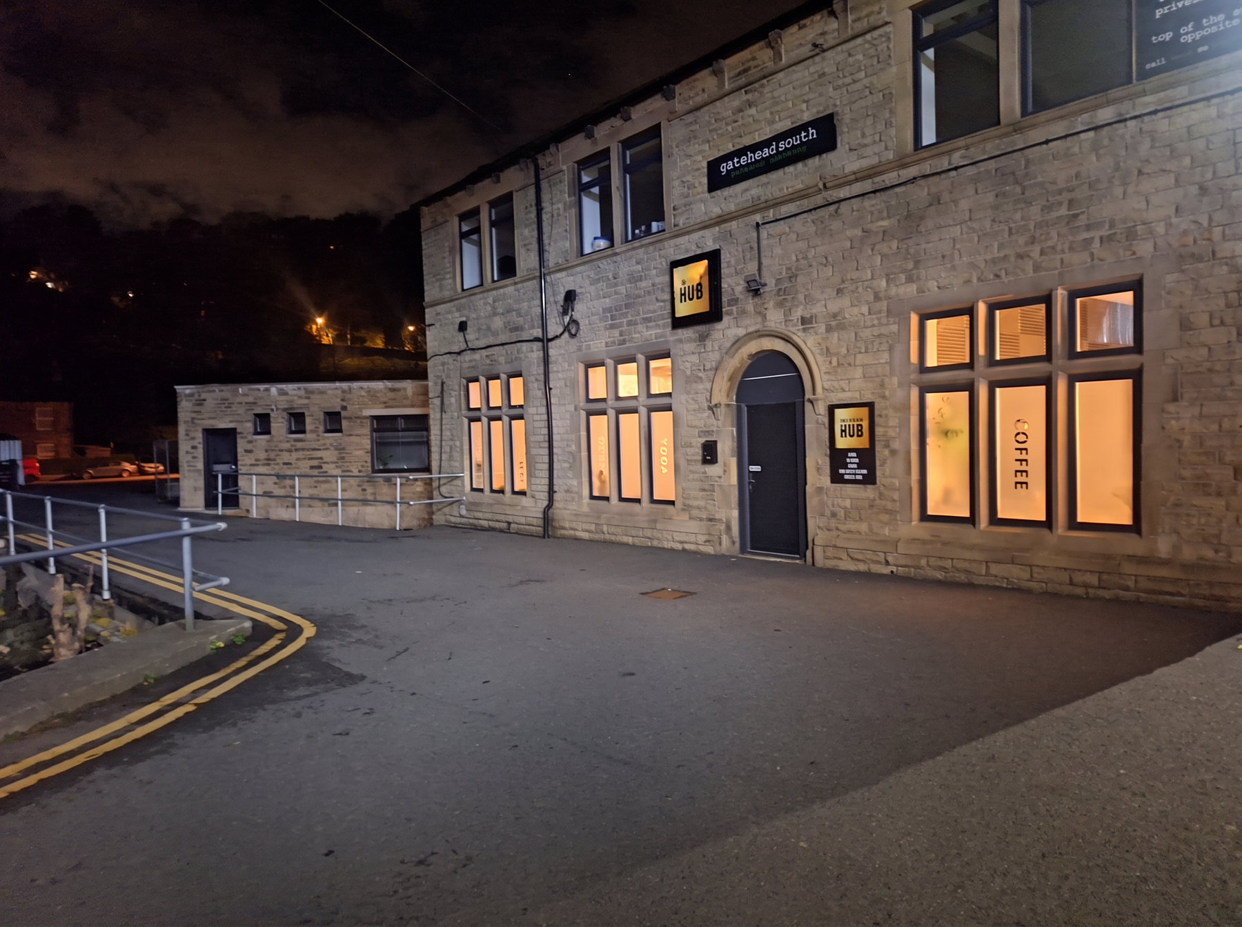 Exterior of The Glow Up Hub venue in Delph at night